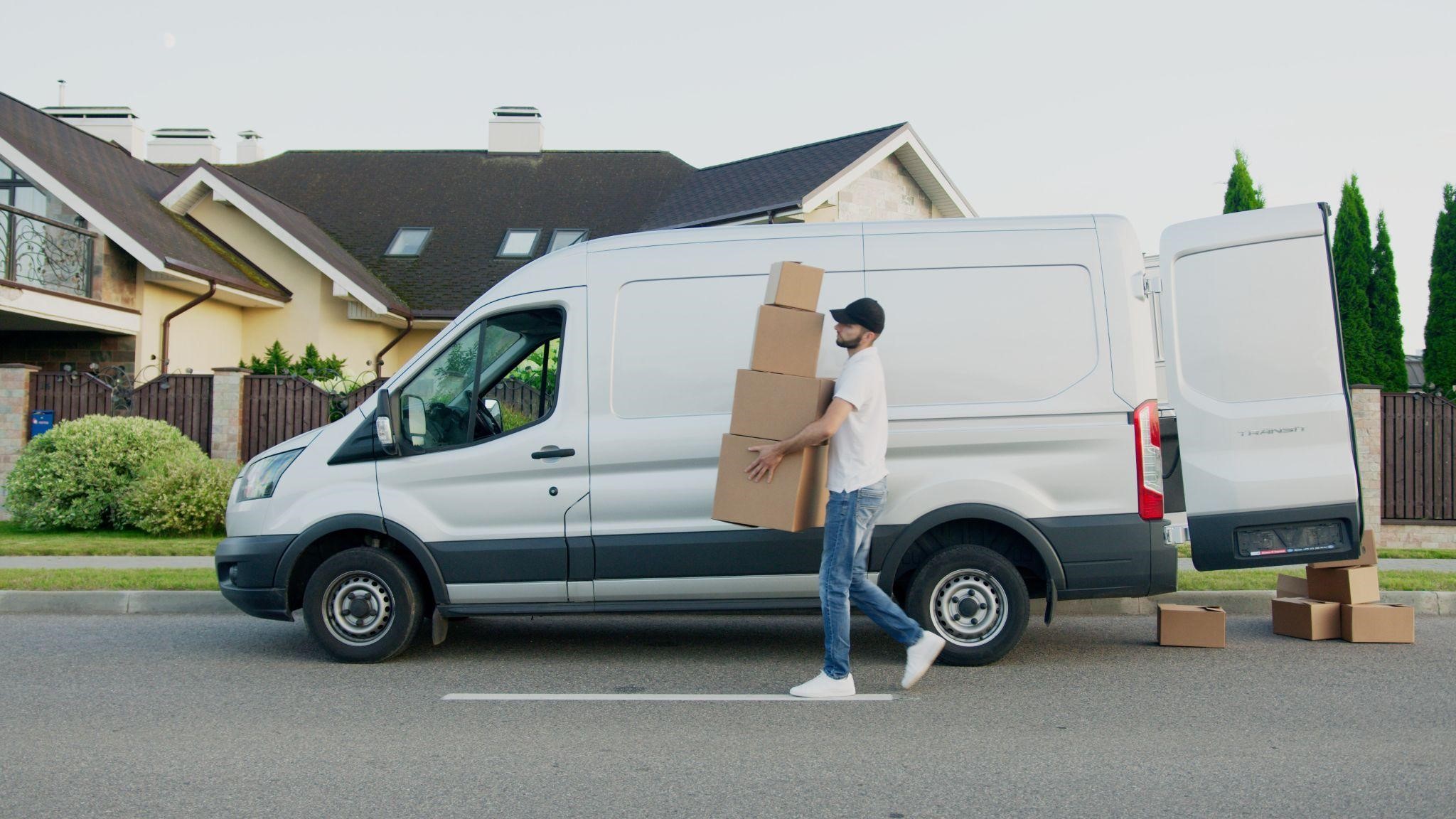 man standing beside a white van