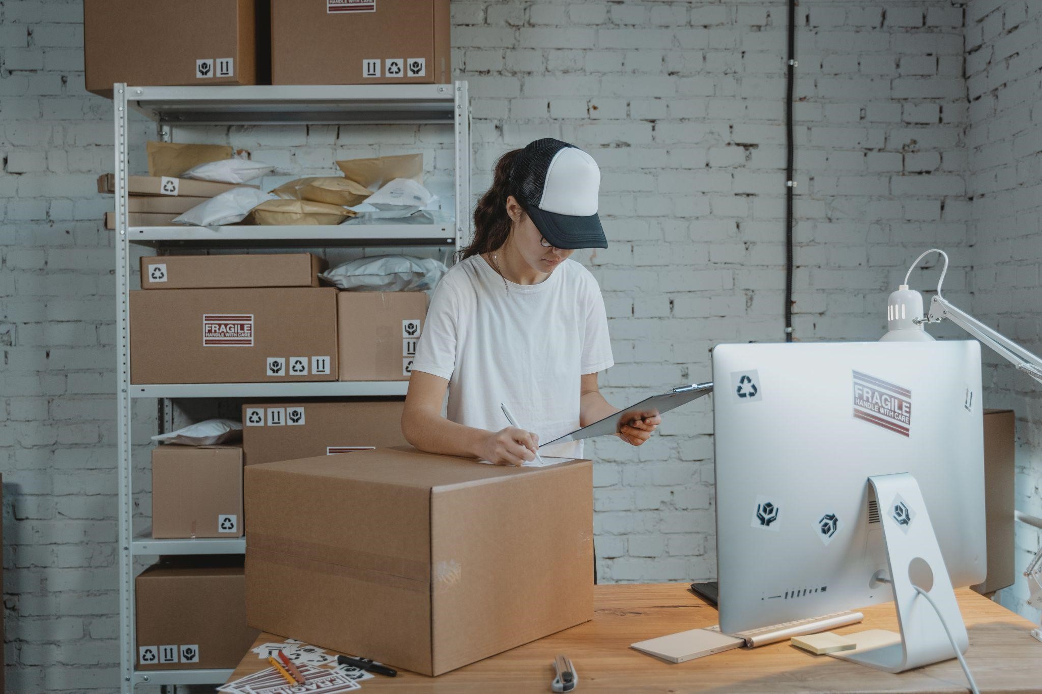 woman writing on a carton box